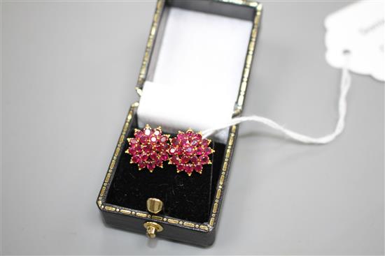 A pair of yellow metal and ruby cluster set flower head earrings, 13mm, gross weight 4.9 grams.